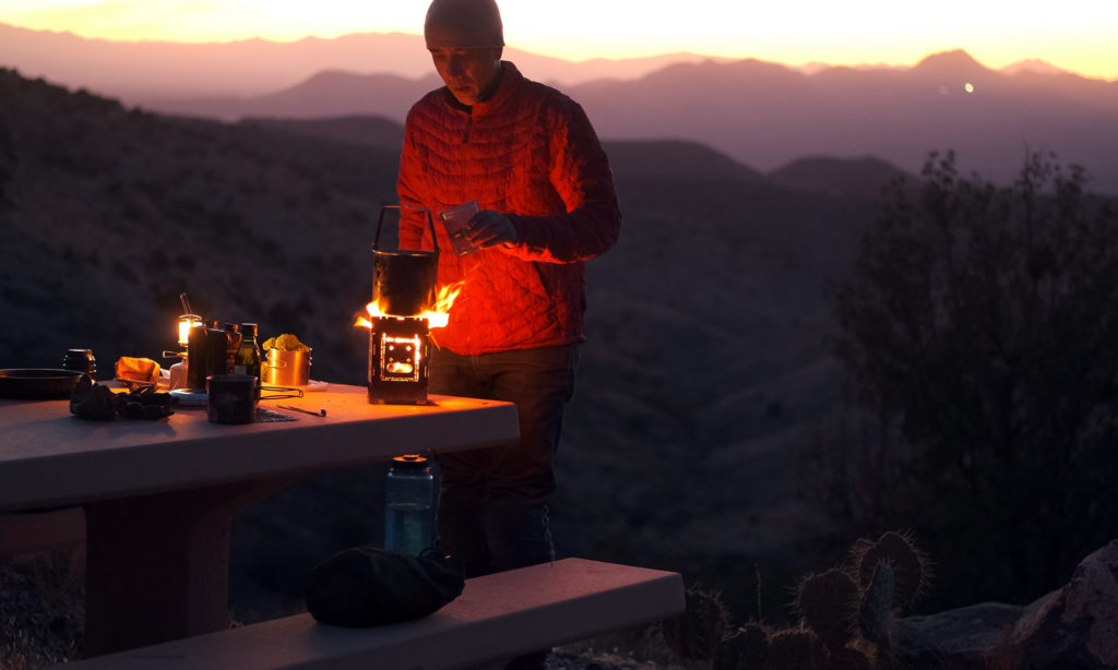 Sterling cooking on Firebox stove with mountains in background