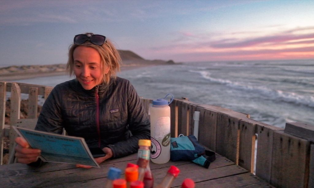 Eva reading menu at seaside restraunt in Baja Mexico