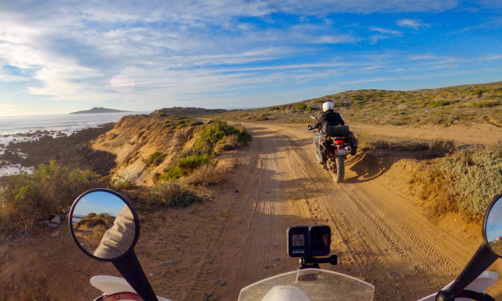 Two motorcyclists riding by ocean in Baja Mexico